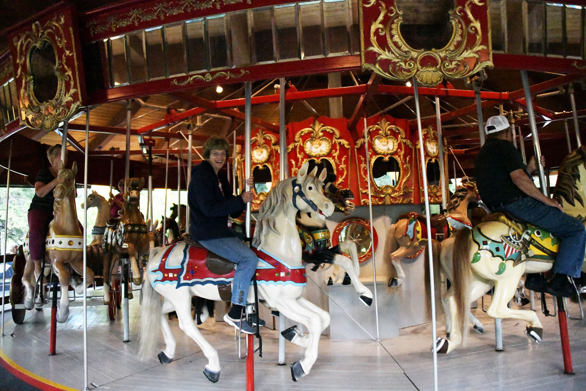 088 Mary Jane Meradith smiles as she rides the 1908 carousel..jpg